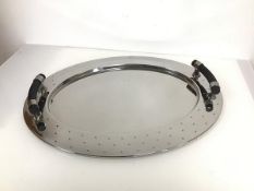 An Alessi oval chromeium plated tray with mirrored effect, with raised handles and studded edge