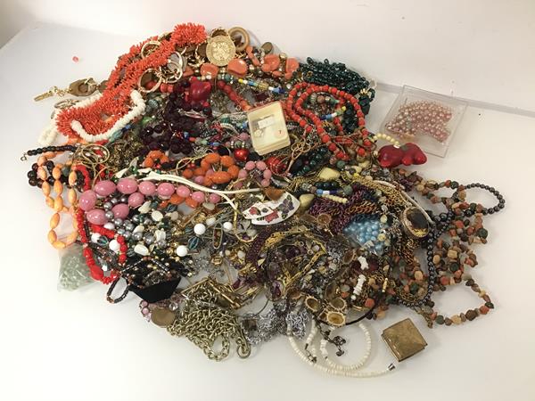 A large assortment of costume jewellery including paste and glass beads, necklaces, bracelets,