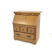 A novelty jewellery box in the form of a bureau, with a fall front above two long drawers (29cm x