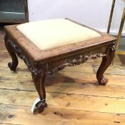 A Victorian rosewood stand of square form, with carved foliate apron and feet, with scroll toes,