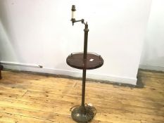 An Edwardian floor lamp with adjustable arm over a circular galleried tier, on circular base (