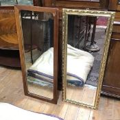 A gilt composition mirror (95cm x 37cm) and another of similar size with wooden frame (2)