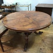 A Victorian circular walnut breakfast table, the tilt top with moulded edge, on carved pedestal base
