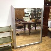 A large wall mirror, the bevelled glass within a silvered frame (137cm x 106cm)