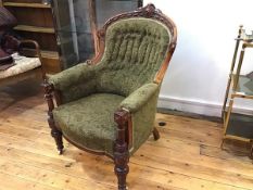 A Victorian walnut drawing room button back tub chair with carved leaf and foliate surmount,