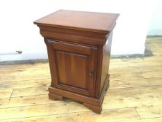 An Olympus bedside cabinet, the moulded edge with frieze drawer bearing stamp, over a