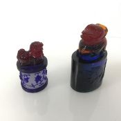 Two Peking glass seals, one of oval form, the other circular, both with lion dog finials (larger: