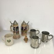 A mixed lot comprising two German ceramic beer steins, with metal lids, one including music box, a