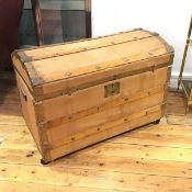 A 19thc oak metal bound dome top saratoga style trunk, with paper lined interior, raised on ball