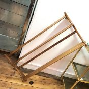 An Ercol light oak two tier wall shelf with shaped end side supports (50cm x 87cm x 12cm)