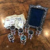 A set of seven Walker & Hall salts, all lacking glass, together with a silver photograph frame and a