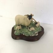 A Border Fine Arts resin figure of a Ewe with Three Lambs (12cm x 20cm x 13cm)