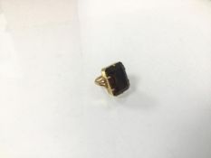 An Indian yellow metal ring mounted cushion cut cairngorm/smokey quartz (F) (6.69g)