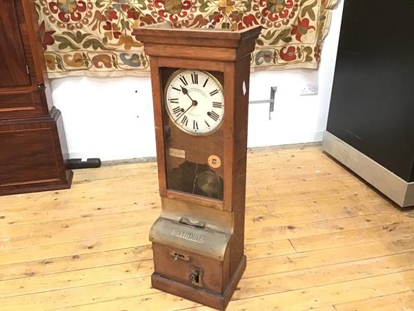An Edwardian clocking-in clock, manufactured by The National Time Company Ltd. complete with key (