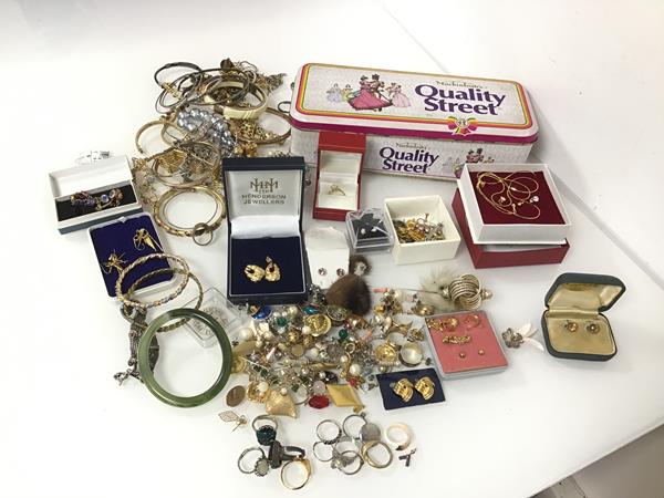 A large assortment of costume jewellery including rings, earrings, bangles, bracelets, pins etc. (