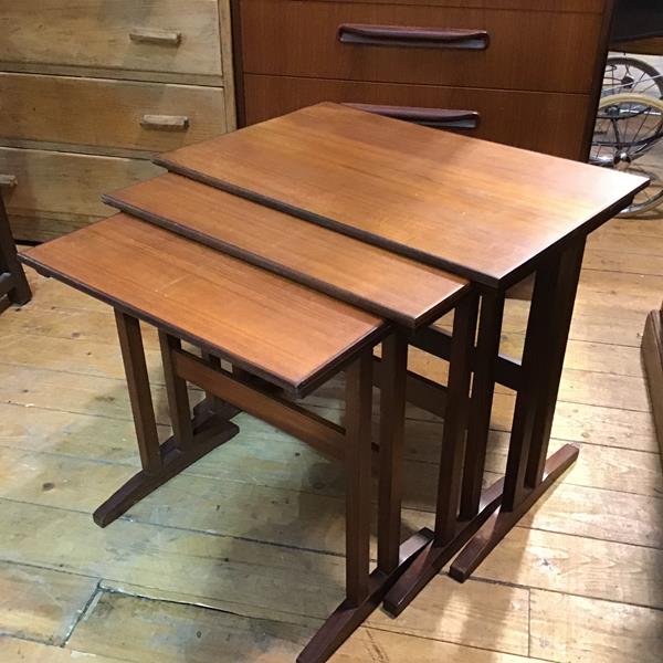 A 1960s/70s mahogany nest of three coffee tables, with rectangular tops and crossbanded borders,