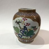 An early 20thc Chinese baluster vase decorated with bird and floral design, enclosed within