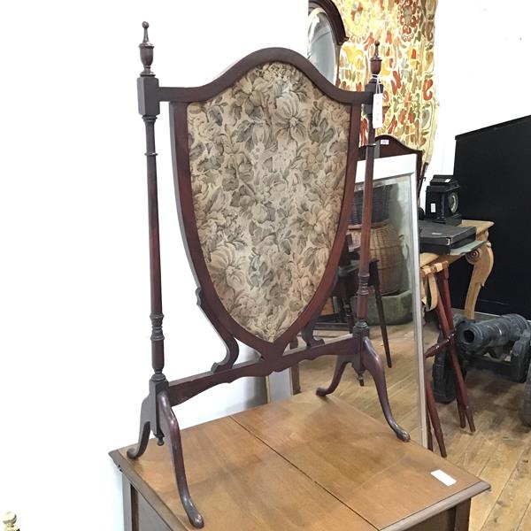 A Georgian style firescreen, with central shield shaped panel, with fabric between turned supports