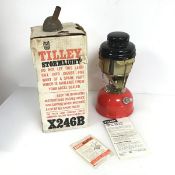 A Tilley storm light, model X246B, having a red base and complete with original box and papers (34cm