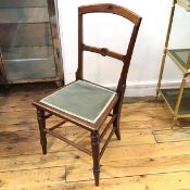A Victorian walnut bedroom chair with arched top and inset seat, on turned supports (83cm x 40cm)