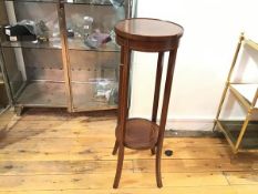 An Edwardian mahogany plant stand, the circular top with inlaid radiating rings of boxwood, with