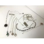 An assortment of silver necklaces with pendants, including turquoise and agate together with a