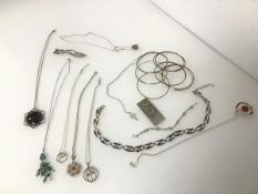 An assortment of silver necklaces with pendants, including turquoise and agate together with a