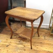 An Edwardian oak octagonal top two tier occasional table raised on scroll supports (74cm x 71cm x