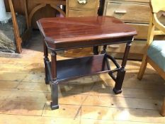 A mahogany coffee table with octagonal top and bookstand undertier, raised on square moulded