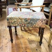 An 18thc bidet converted to a stool , with linen upholstery, decorated with multiple flowerheads,