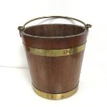 A teak brass bound swing handled bucket (27cm x 30cm)