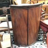 A George III mahogany bow front wall corner cabinet, with dentil cornice (a/f) and twin inlaid panel