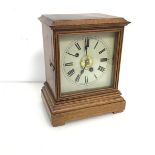 A 1950s oak mantel clock, the dial with Roman numerals and subsidiary dial with Arabic numerals,