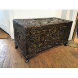 A mid 20thc Hong Kong camphorwood chest, with traditional Chinese scenes carved in relief, on