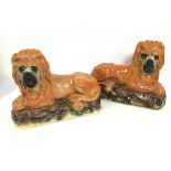 A pair of late Victorian Staffordshire chimney lions (25cm x 33cm x 14cm)