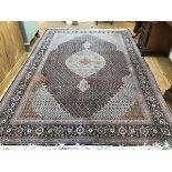 A fine hand knotted North West Persian carpet, the chocolate brown field with lattice motifs and