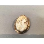 A 9ct gold Victorian oval shell carved cameo brooch with engraved border, stamped verso 9ct, with