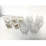 A set of five short whisky glasses, all with gilt rims and painted bird decoration and a set of