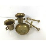 A pair of brass mortars of bell form (tallest: 10cm x 13cm x 10cm), with pestles and another bowl