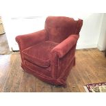 An Edwardian mahogany framed tub chair with scroll back and arms, in terracotta pattern fabric,