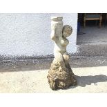 A composition garden statue of a water carrier, with hole drilled in urn for bird bath, stamped
