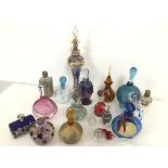 A collection of glass perfume bottles of various designs, including cased glass and floral