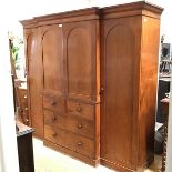 A 19thc mahogany breakfront wardrobe with moulded cornice above a pair of arched centre panel doors,