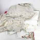 An assortment of 1930s and later linen including table cloths, bed sheets, pillowcases, some with