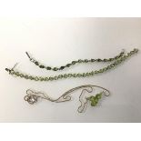 A silver peridot pendant necklace (25cm), and a pair of peridot silver bracelets (3)