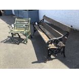 A garden bench with painted cast iron supports, with foliate decoration with wooden seats and back