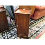 A Victorian bedside cabinet with galleried top and moulded edge over a single door with shelved