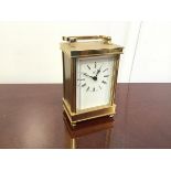 A Weiss brass carriage clock, the dial with Roman numerals, on bun feet (12cm x 9cm x 6cm)