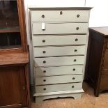 An eight drawer painted chest in soft grey green, with moulded top and bracket feet (135cm x 76cm