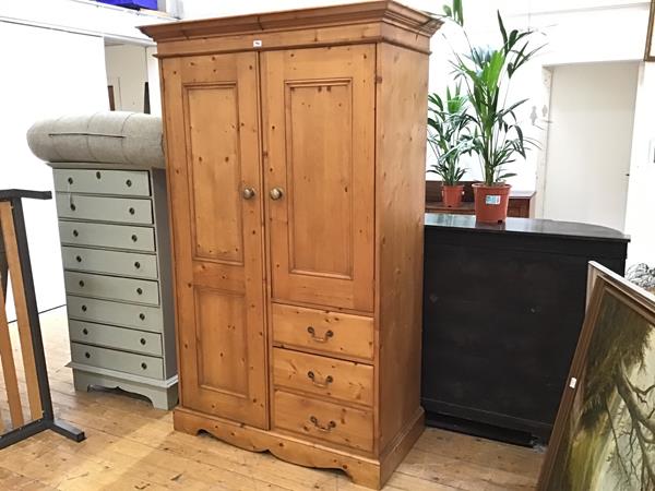 A modern John Lewis pine upright gentleman's linen style press with twin panel doors to top above